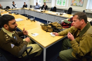 Pakistani army Lt. Col Fiaz Khan attempts to negotiate with a warlord role-played by Tamir Sinai during an exercise at the George C. Marshall European Center for Security Studies May 16. The exercise tested the negotiating skills of participants in the Program in Advanced Security Studies at the Marshall Center. (DOD Photo/Army Sgt. 1st Class Andrew Smith/RELEASED)